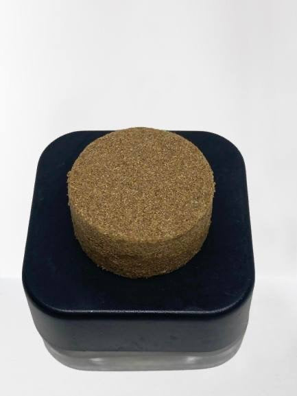Close-up of 1 gram THCa Kief concentrate from I Am Hemp Inc, showing the fine, crystalline texture and light golden color.
